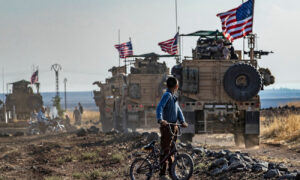 A convoy of US armored vehicles drives near the al-Qahtaniyah city to the northeast of al-Hasakah governorate - 31 October 2019 (AFP)
