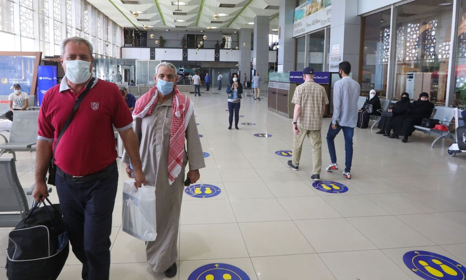 Travelers inside Damascus International Airport (AFP)