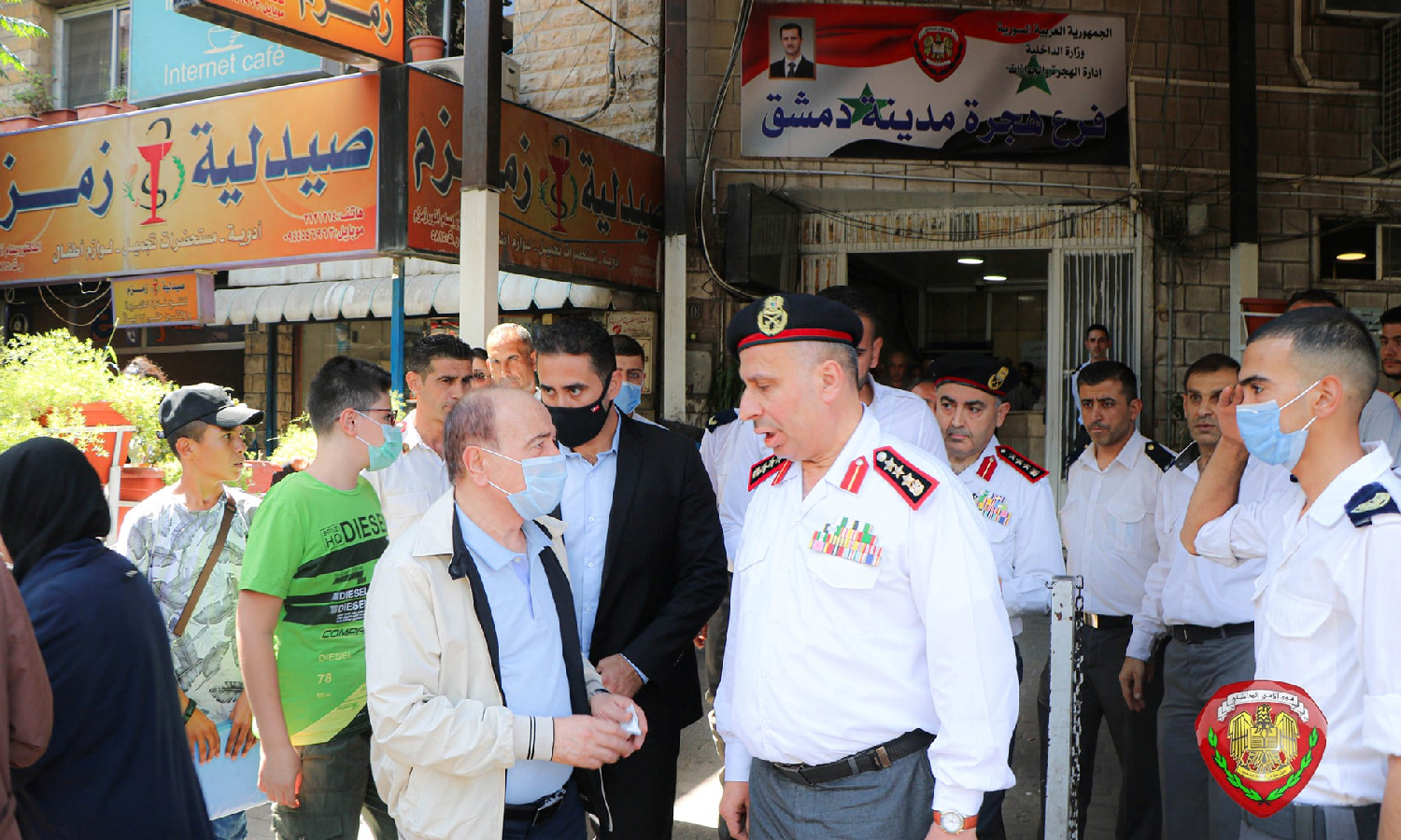 Syrian Minister of Interior, Mohammad al-Rahmoun, talking to citizens in front of the Immigration and Passports Directorate in Damascus (Syrian Ministry of Interior)