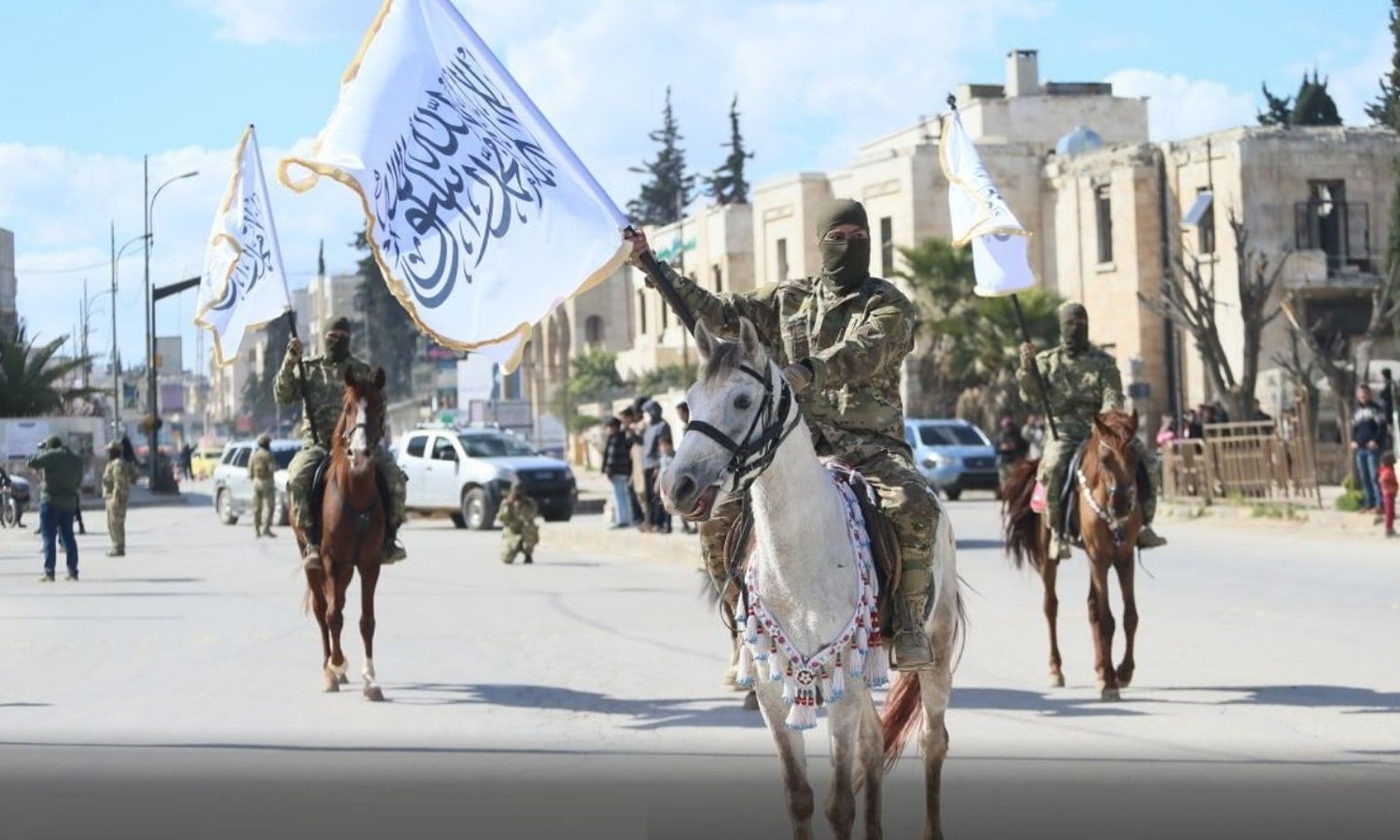 A military parade by Hayat Tahrir al-Sham (HTS) fighters in al-Bab city, commemorating the Syrian revolution’s tenth anniversary - 18 March 2021 (Amjad Media)