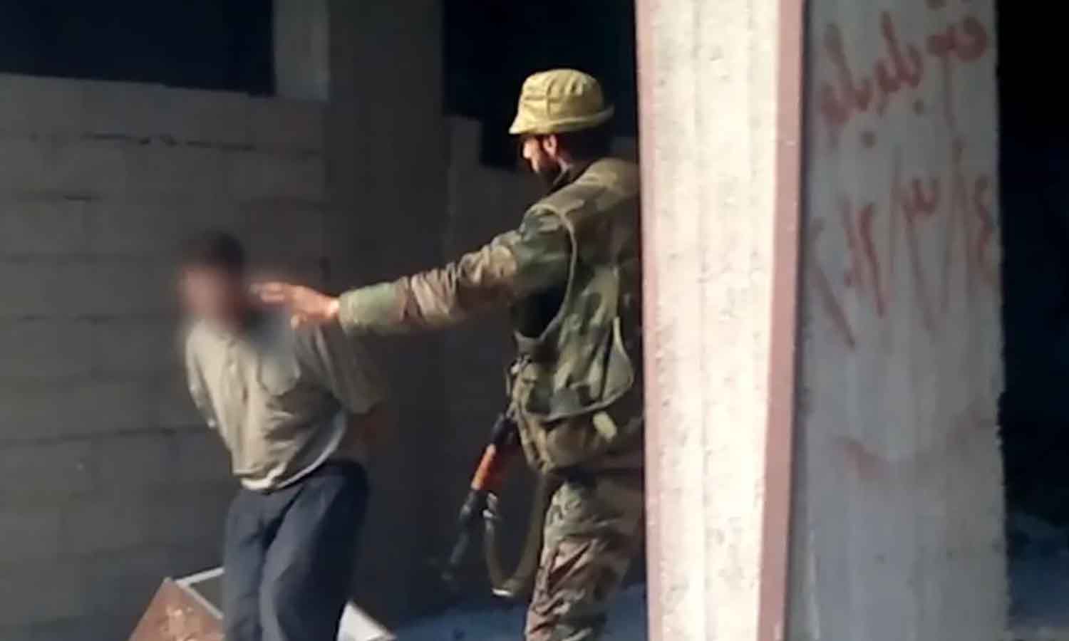 The gunman with a fishing hat in a still from the Tadamon massacre video (The Guardian) 