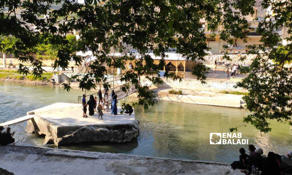 People standing on the banks of the Orontes River in the Darkush region, northwestern Syria - 25 May 2022 (Enab Baladi)