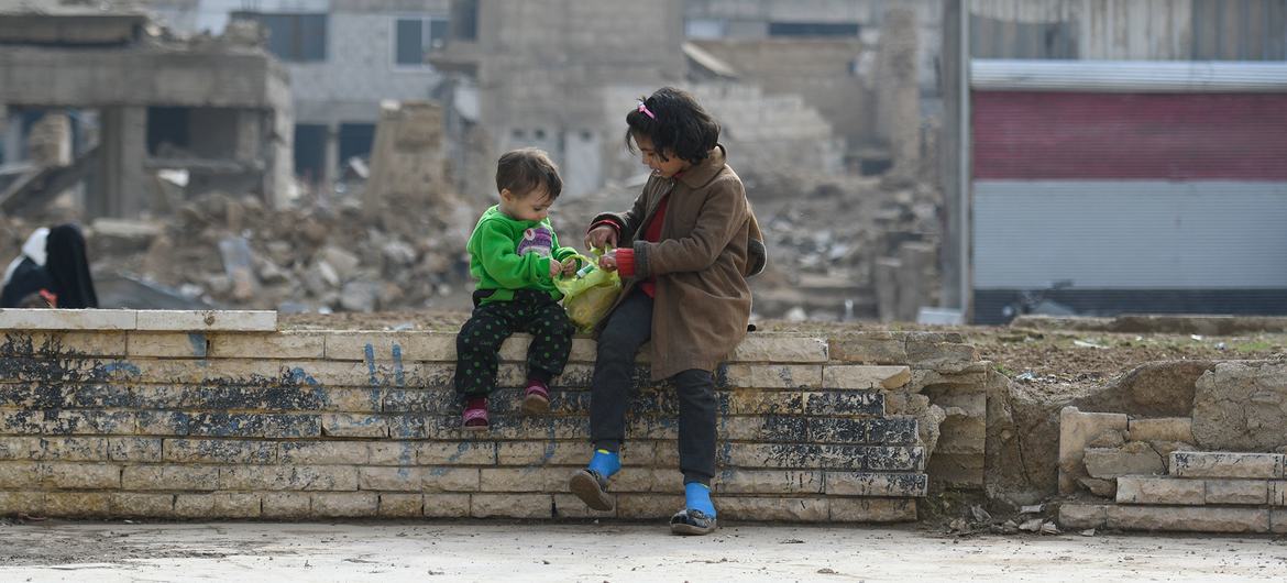 Two children sitting on a wall in Douma city in Damascus countryside - 29 June 2022 (UN)