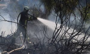 A member of the Syrian Civil Defense’s fire fighting teams extinguishing a fire in Souran, the northern countryside of Aleppo - 29 July 2022 (Civil Defense)