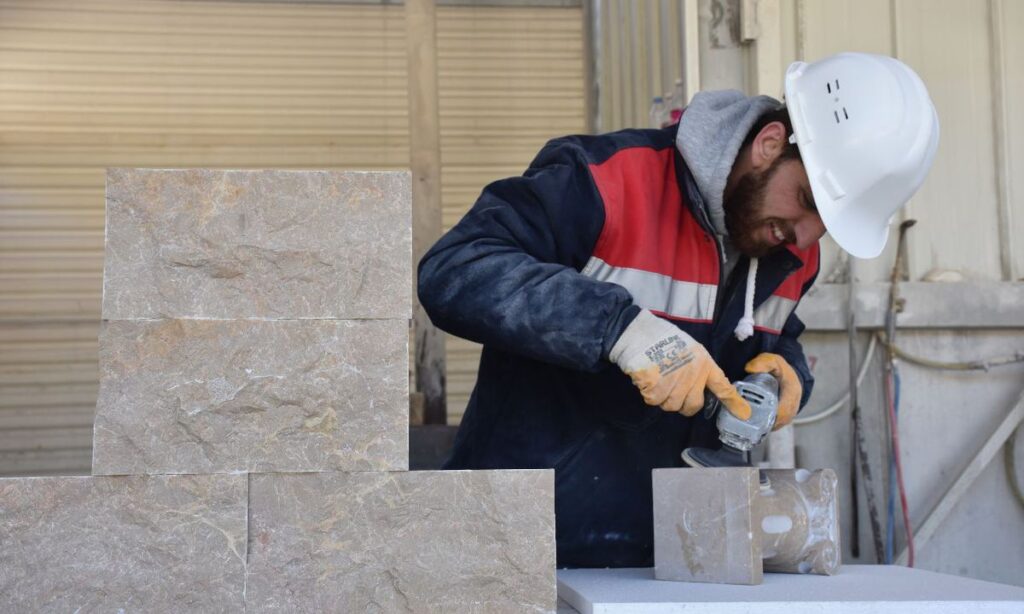 Mohammed Lozi Habab, who fled the war in Syria and sought refuge in Turkey, draws attention to the decorative products he makes of marble by hand in a marble factory in Bilecik, Turkey - 12 February 2022 (Anadolu Agency)