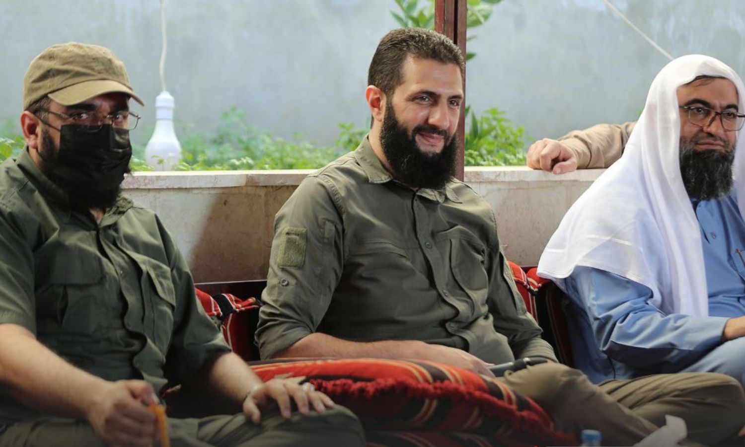 HTS senior commander Mazhar al-Wis (R), HTS general commander Abu Mohammad al-Jolani (C), and commander Abu Maria al-Qahtani (L), in a meeting with the notables of the eastern region - 14 July 2022 (Amjad)