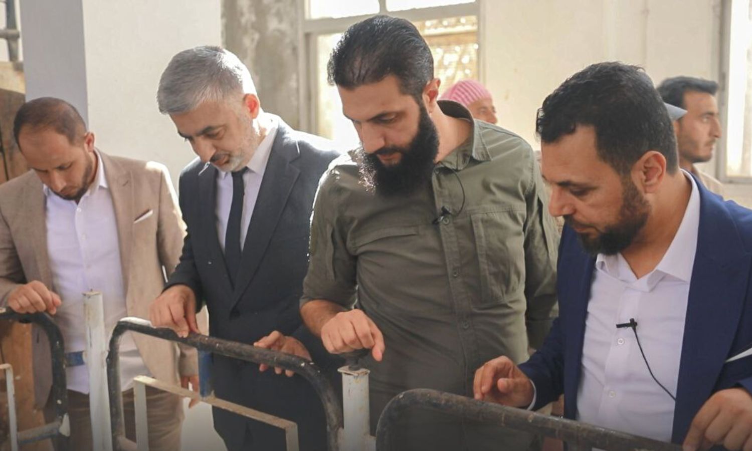 HTS General Commander Abu Mohammed al-Golani and members of the Salvation government during the setting up of the water pumping project in the western countryside of Idlib - 23 July 2022 (Amjad)