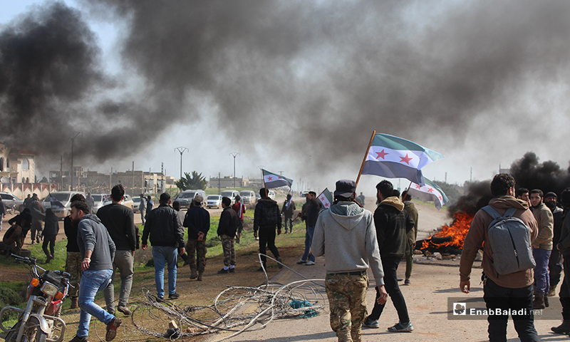 Local protesters on the Aleppo-Latakia M4 international highway, protesting against the Russian forces who began to patrol on the strategic road - 15 March 2020 (Enab Baladi)