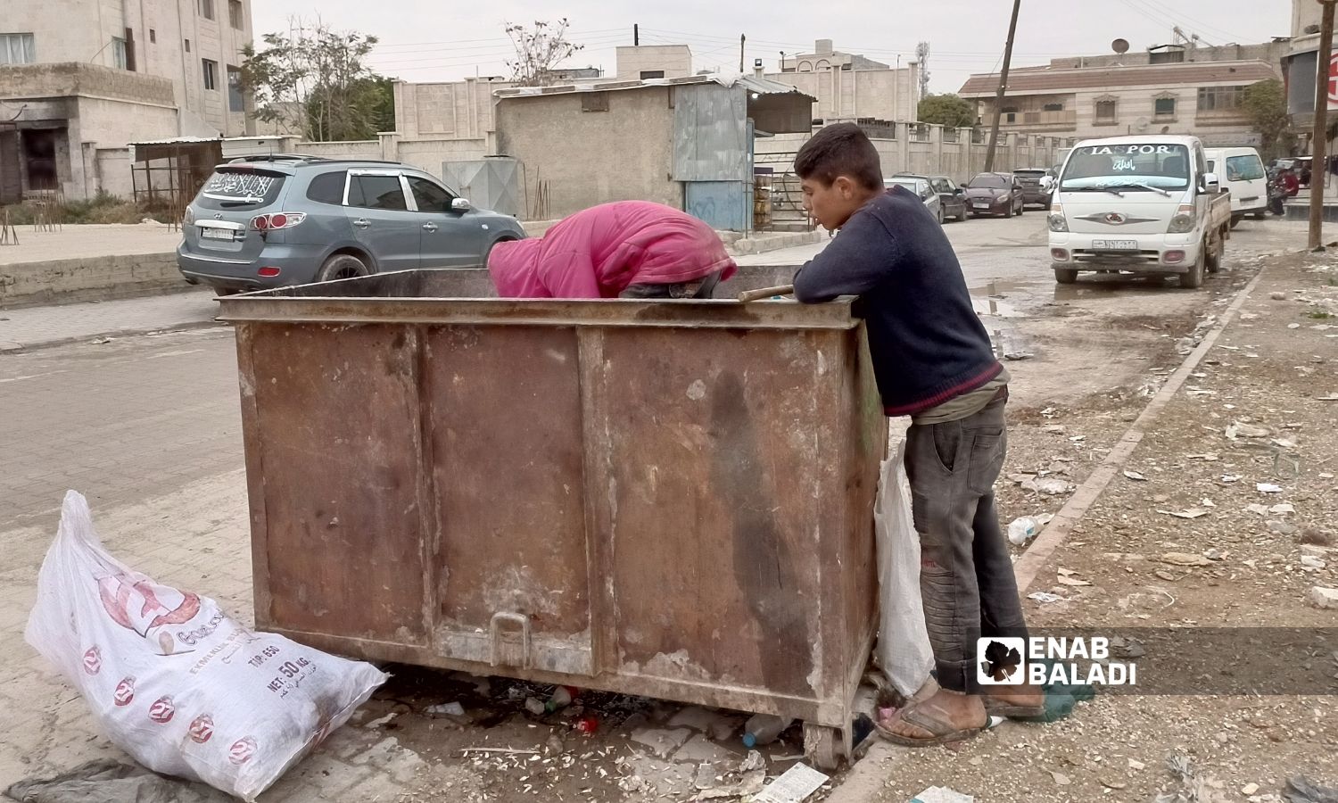 Two children scavenge for recyclable waste to sell in northern Azaz city - 10 November 2022 (Enab Baladi/Dayan Junpaz)