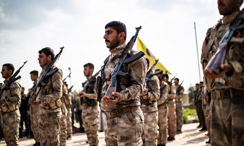 Members of the Syrian Democratic Forces (SDF) taking part in the funeral of an SDF fighter in Deir Ezzor, northeastern Syria - 10 April 2019 (AFP)