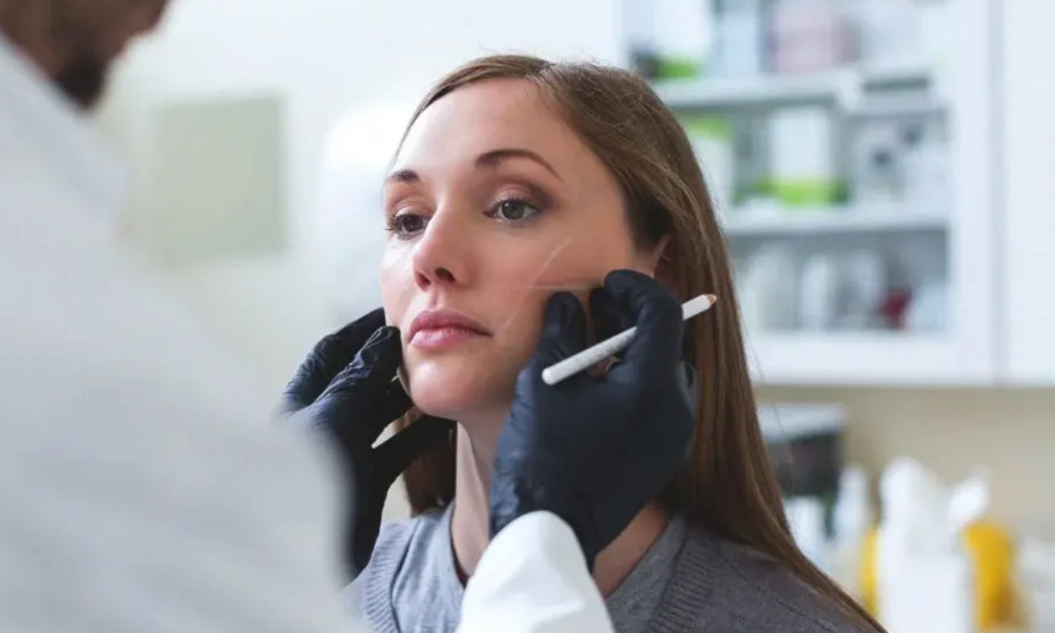 Plastic surgeon examining a young woman (Illustration/Getty Images)