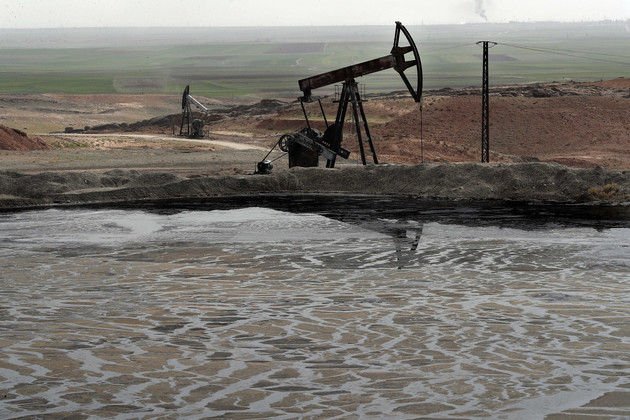An oil pond in an oil field under the control of the SDF-held region of Rmeilan in northeastern al-Hasakah governorate (AP)