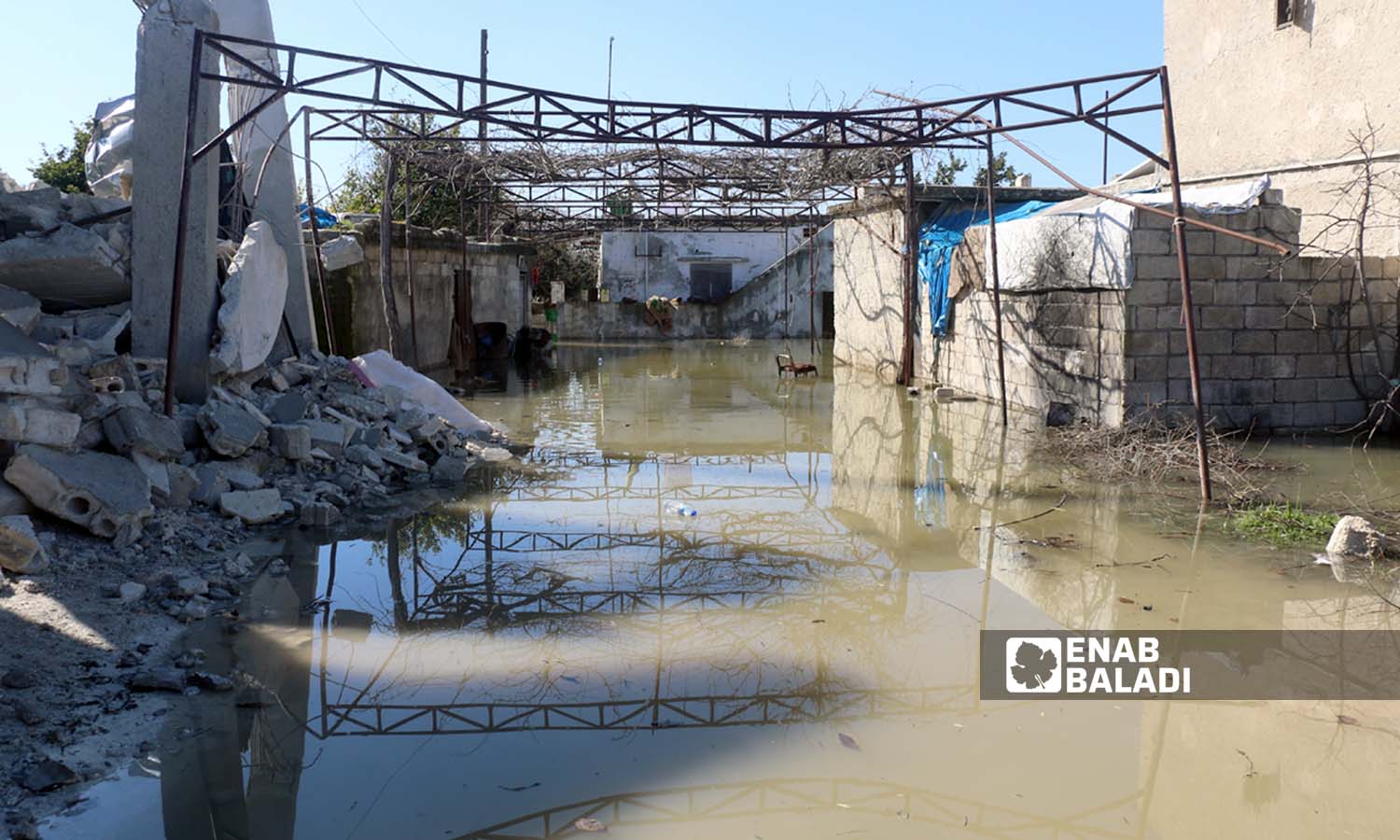 The waters of the Orontes (Asi) River flood many houses in the village of al-Talul near the city of Salqin - February 9, 2023 (Enab Baladi/Iyad Abdul Jawad)