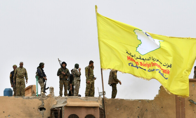Fighters of the Syrian Democratic Forces (SDF) on the roof of a house in northeastern Syria (Getty Images)