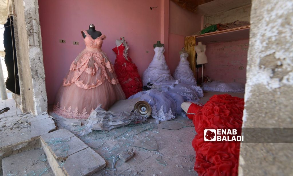 Bridal costumes in a destroyed shop in the northwestern city of Idlib - October 2020 (Enab Baladi/Youssef Ghuraibi)