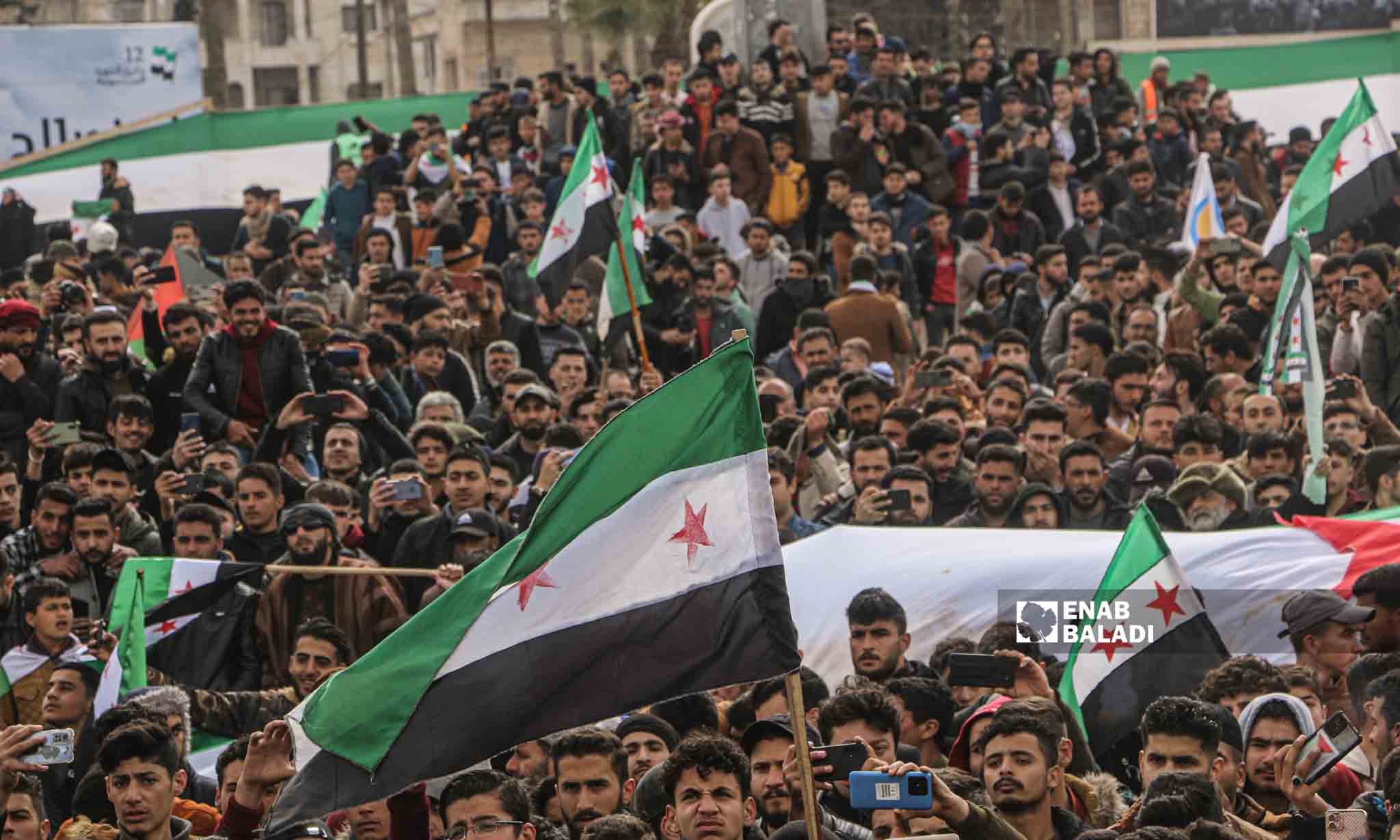 A demonstration in Idlib city to commemorate the 12th anniversary of the Syrian revolution - March 15, 2023 (Enab Baladi/Anas al-Khouli)