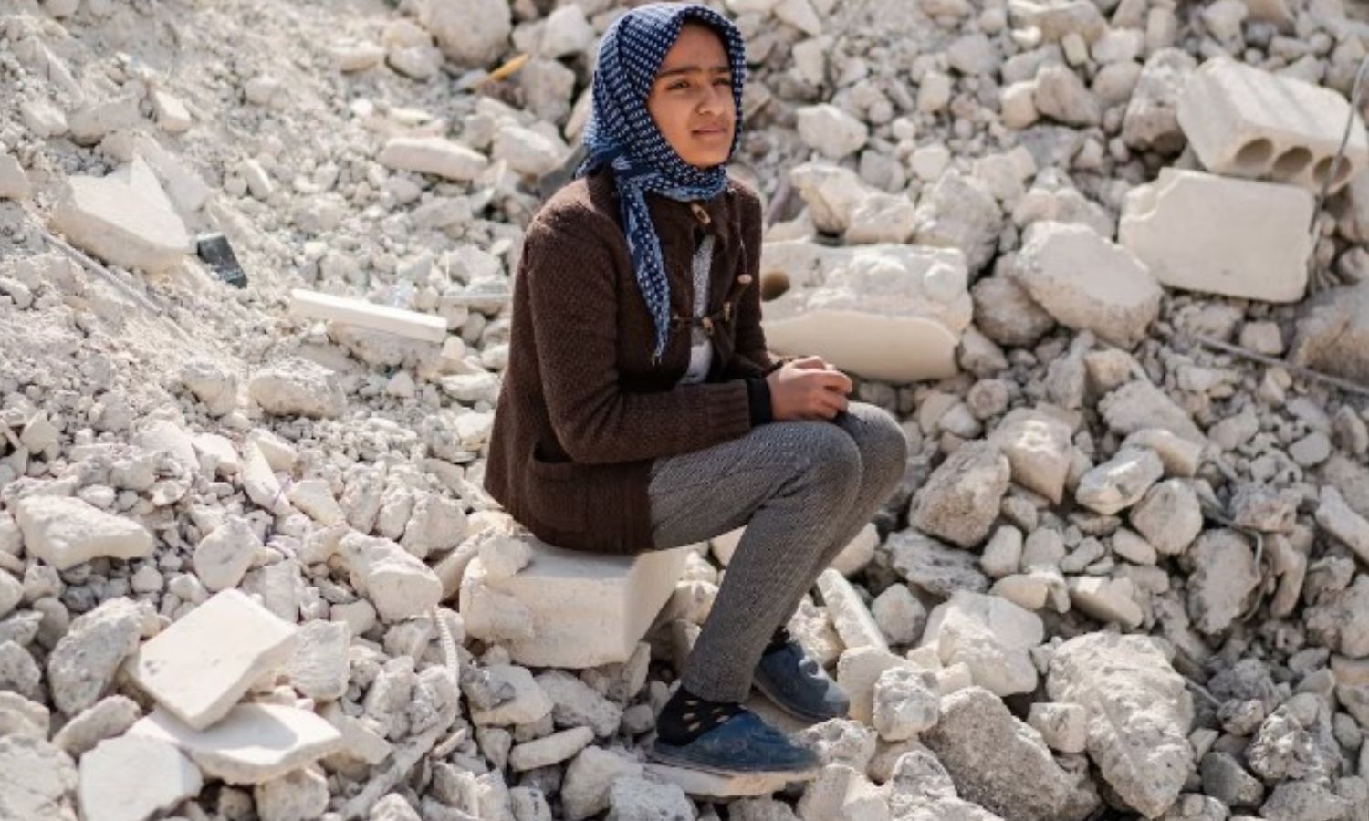 A child sitting on the rubble of her destroyed house in Jindires - February 14, 2023 (The Washington Post)