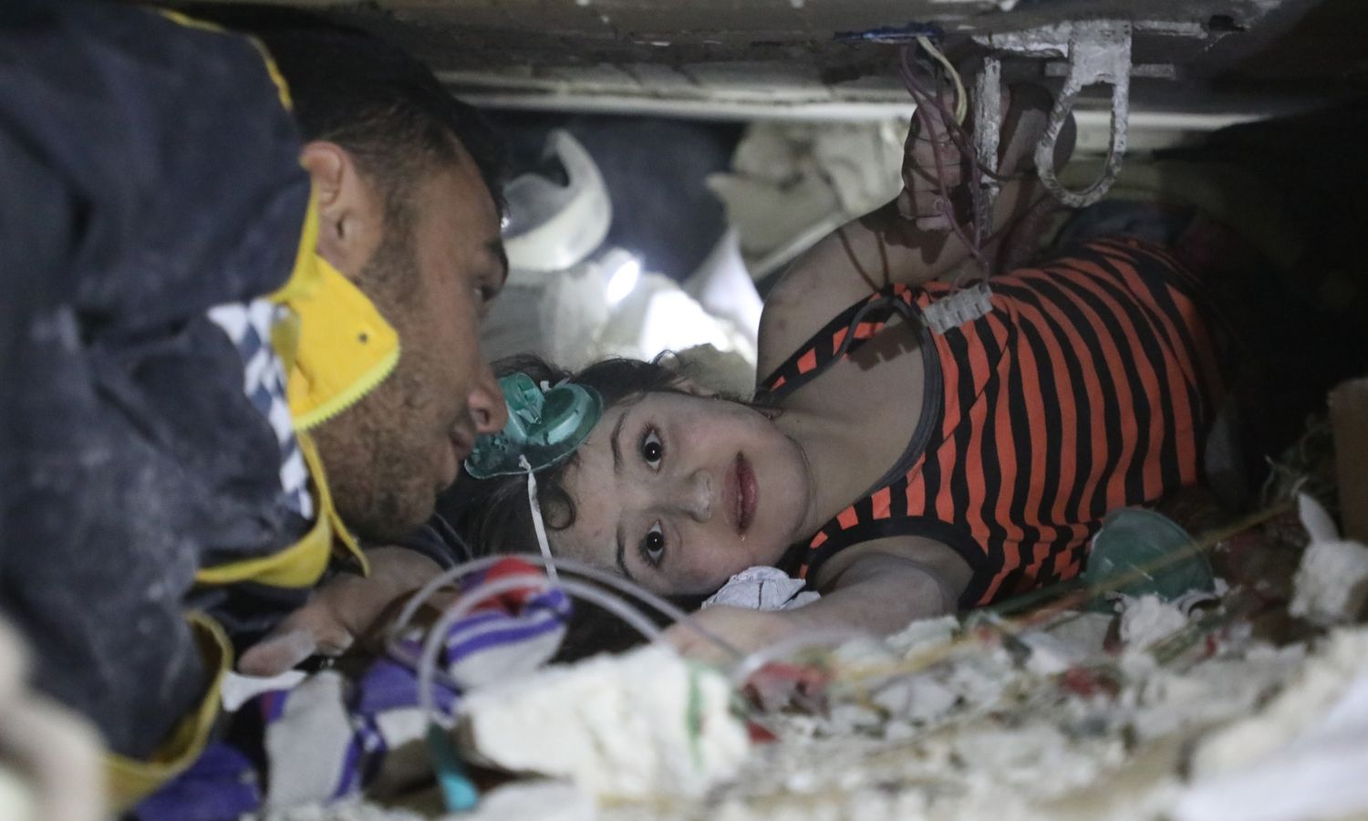 Syrian child Sham under the rubble in the town of Armanaz in Idlib countryside before she was rescued by the Syria Civil Defense teams - February 7, 2023 (Facebook/Civil Defense)