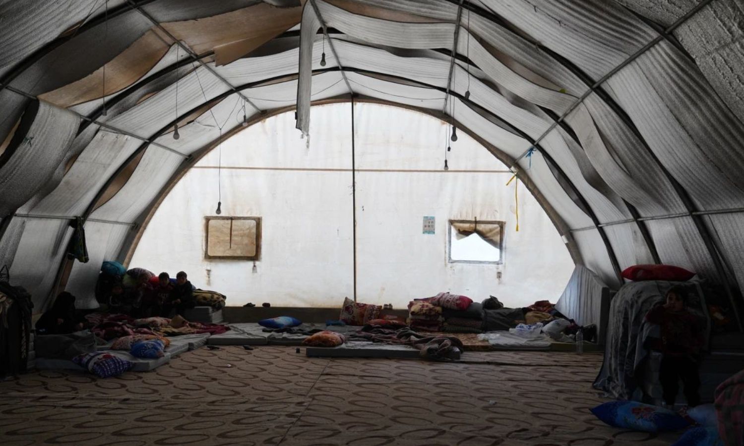 About 100 quake-affected families live in this tent in the Maarat Tamsrin town in Idlib countryside - February 21, 2023 (OCHA)