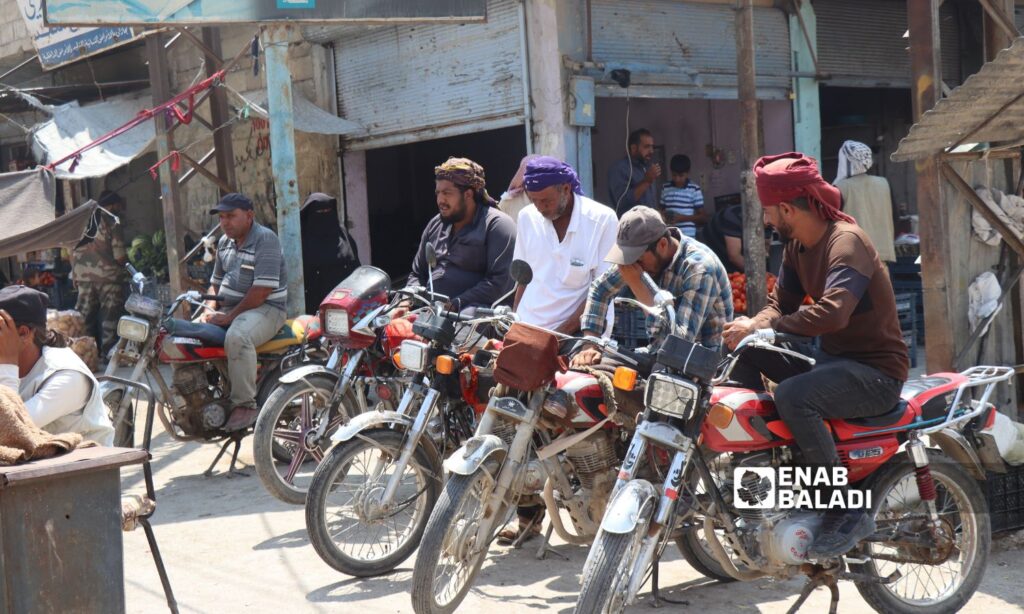 A group of men waiting for a job opportunity in the northeastern city of Ras al-Ain - July 12, 2023 (Enab Baladi/Hussein Sha’bo)