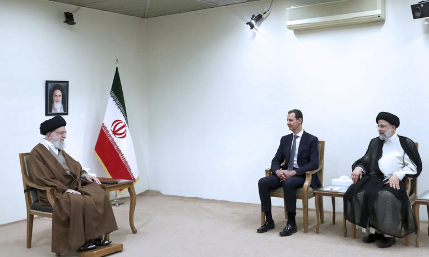 Iranian President Ebrahim Raisi, Syrian regime head Bashar al-Assad, and Iranian Supreme Leader Ayatollah Khomeini in Tehran - May 8, 2022 (AP)