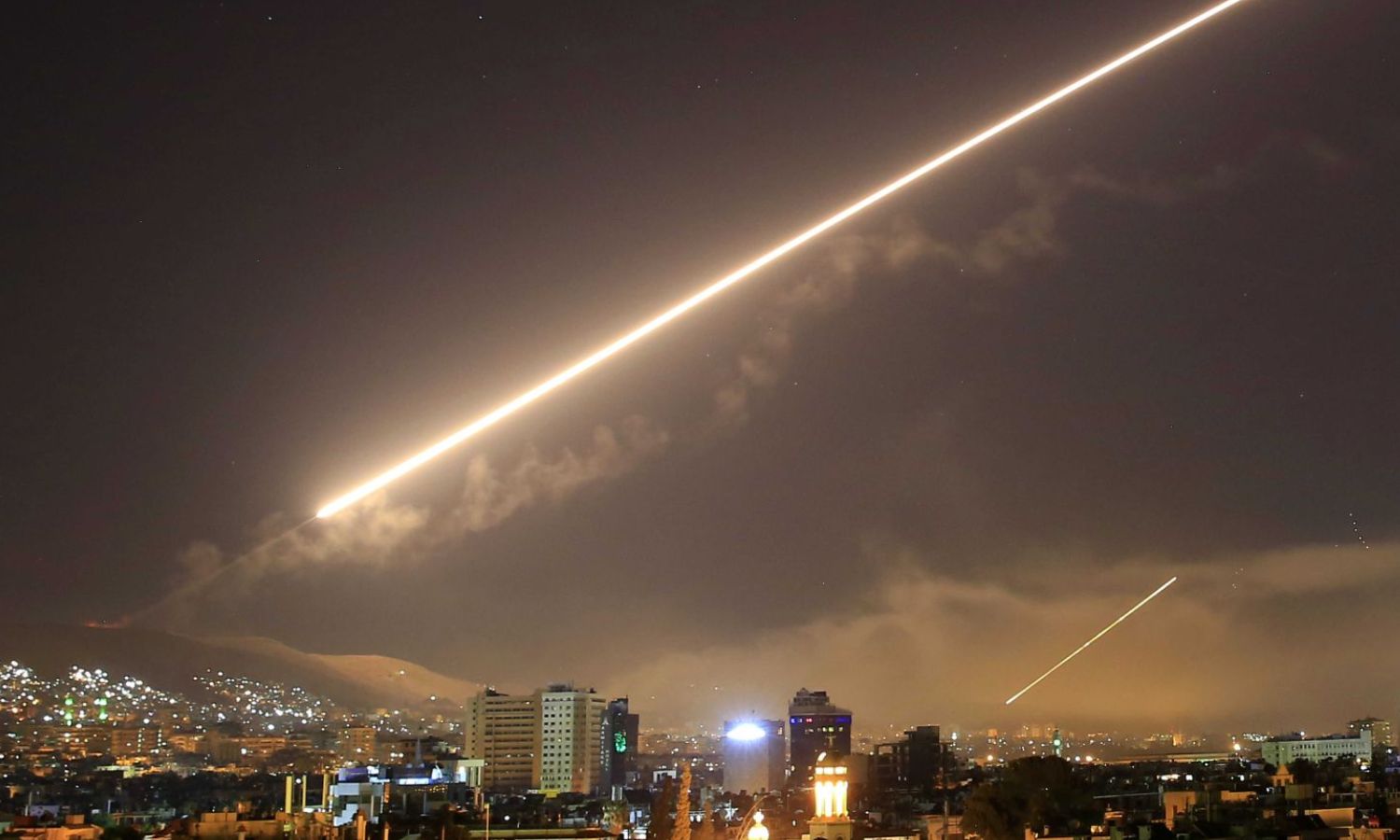 Syrian air defense systems intercepting Israeli air missiles in the sky of the capital, Damascus (AP Photo/Hassan Ammar)
