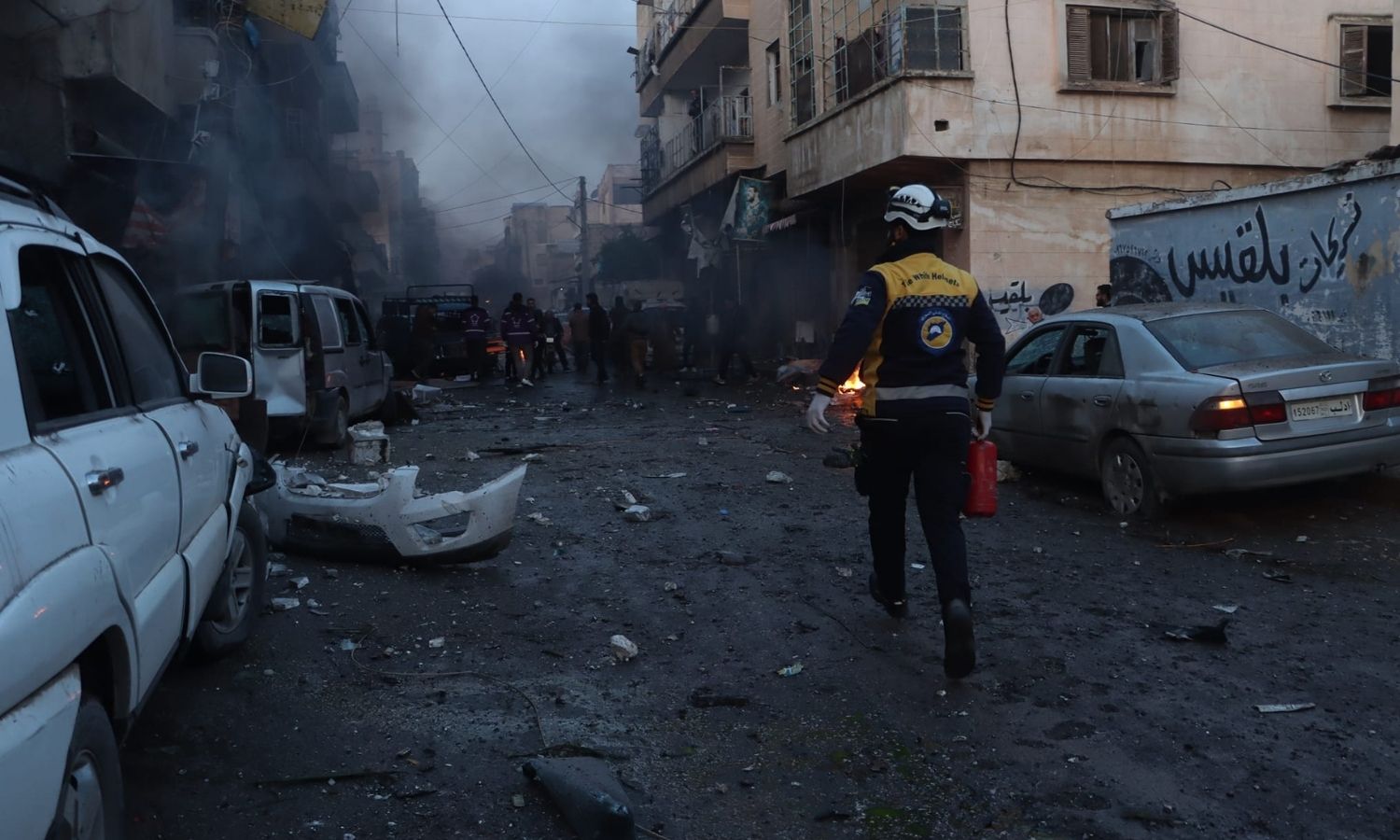 A volunteer with the Syria Civil Defense during a rescue operation after the Syrian regime forces shelled the carpenters and industrialists area in the city of Idlib - December 9, 2023 (Syria Civil Defense)