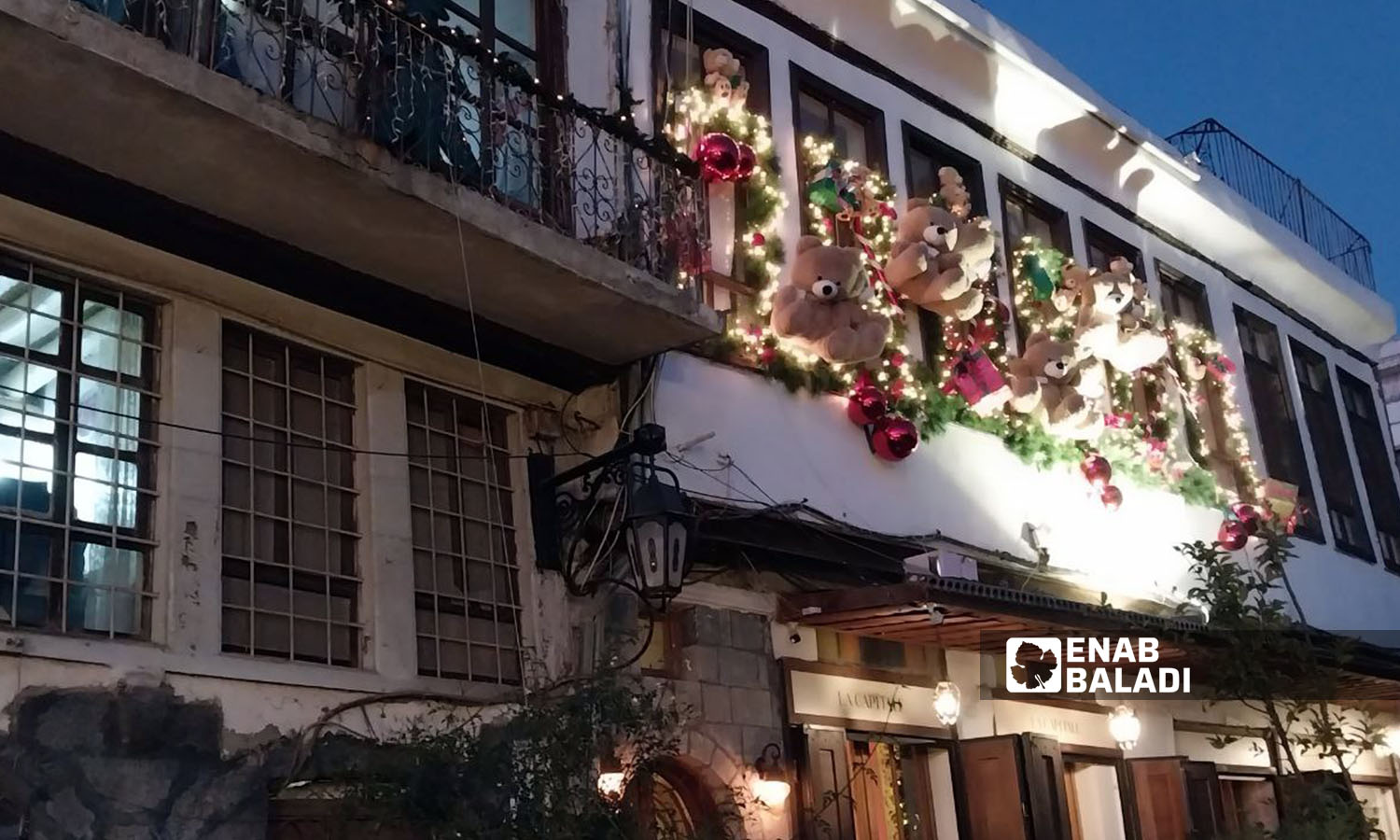 Christmas and New Year’s decorations hung on houses and shops’ walls in Bab Sharqi neighborhood in Damascus - December 26, 2023 (Enab Baladi/Sarah al-Ahmad)
