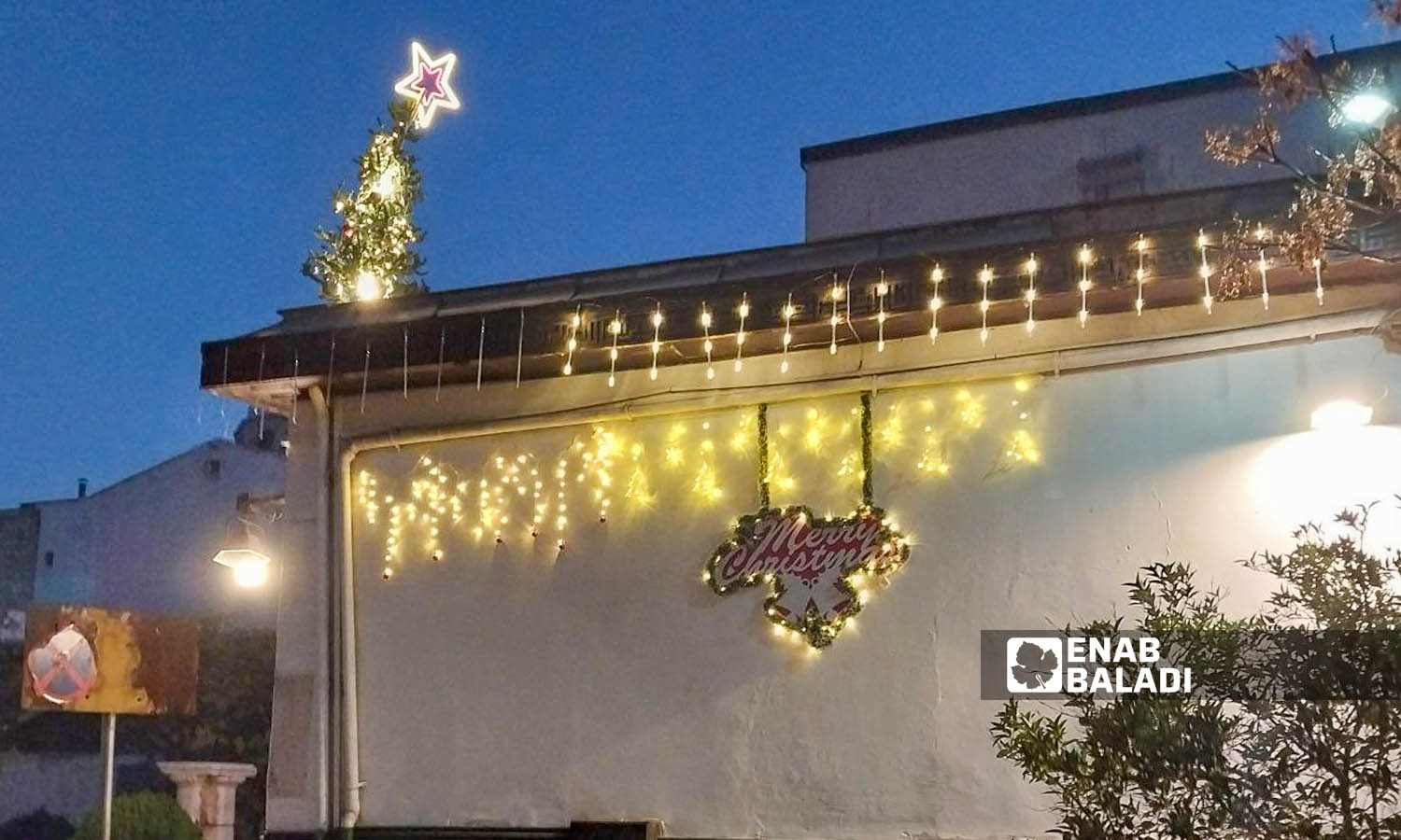 Christmas and New Year’s decorations hung on houses and shops’ walls in Bab Sharqi neighborhood in Damascus - December 26, 2023 (Enab Baladi/Sarah al-Ahmad)
