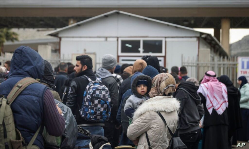 Syrians waiting to cross to Syria from Turkey at Bab al-Hawa border crossing following the Feb. 6 earthquake - 2023 (AP)
