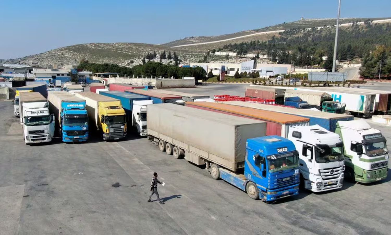 Trucks carrying aid from the UN World Food Programme (WFP) are stopped at the Bab al-Hawa crossing - February 20, 2023 (Reuters)