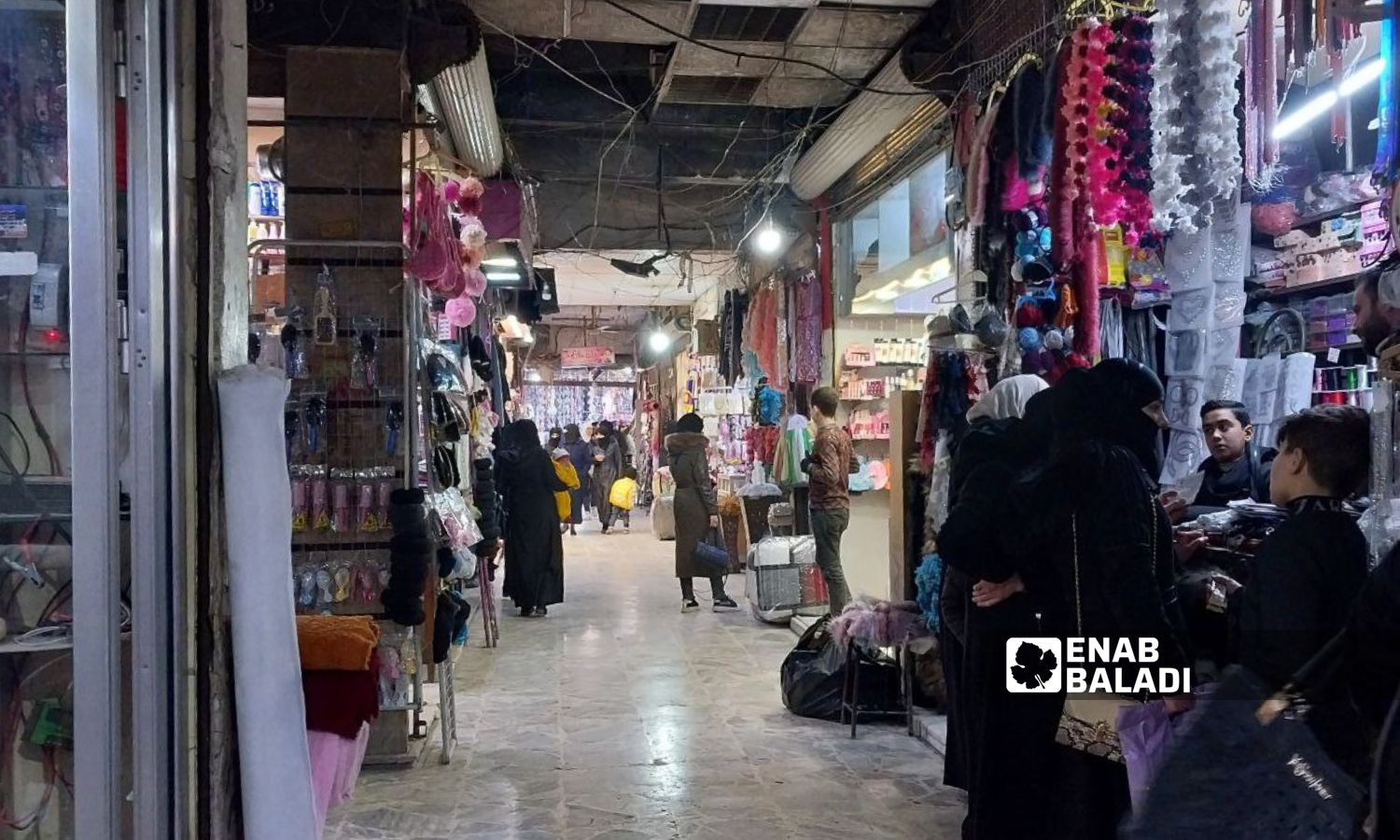 A clothing market in the al-Jalaa Street in Douma city, rural Damascus - January 22, 2024 (Enab Baladi/Sarah al-Ahmad)
