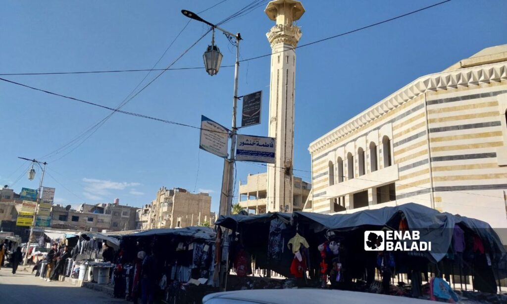 Clothing stalls in the al-Jalaa Street in front of the Great Mosque in Douma city, rural Damascus - January 22, 2024 (Enab Baladi/Sarah al-Ahmad)