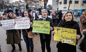 Protesters stand in front of the Water Establishment in As-Suwayda, demanding political change in Syria - February 19, 2024 (Enab Baladi)
