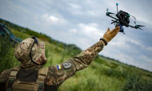 A Ukrainian soldier launches an "FPV" drone armed with munitions (Militarnyi)