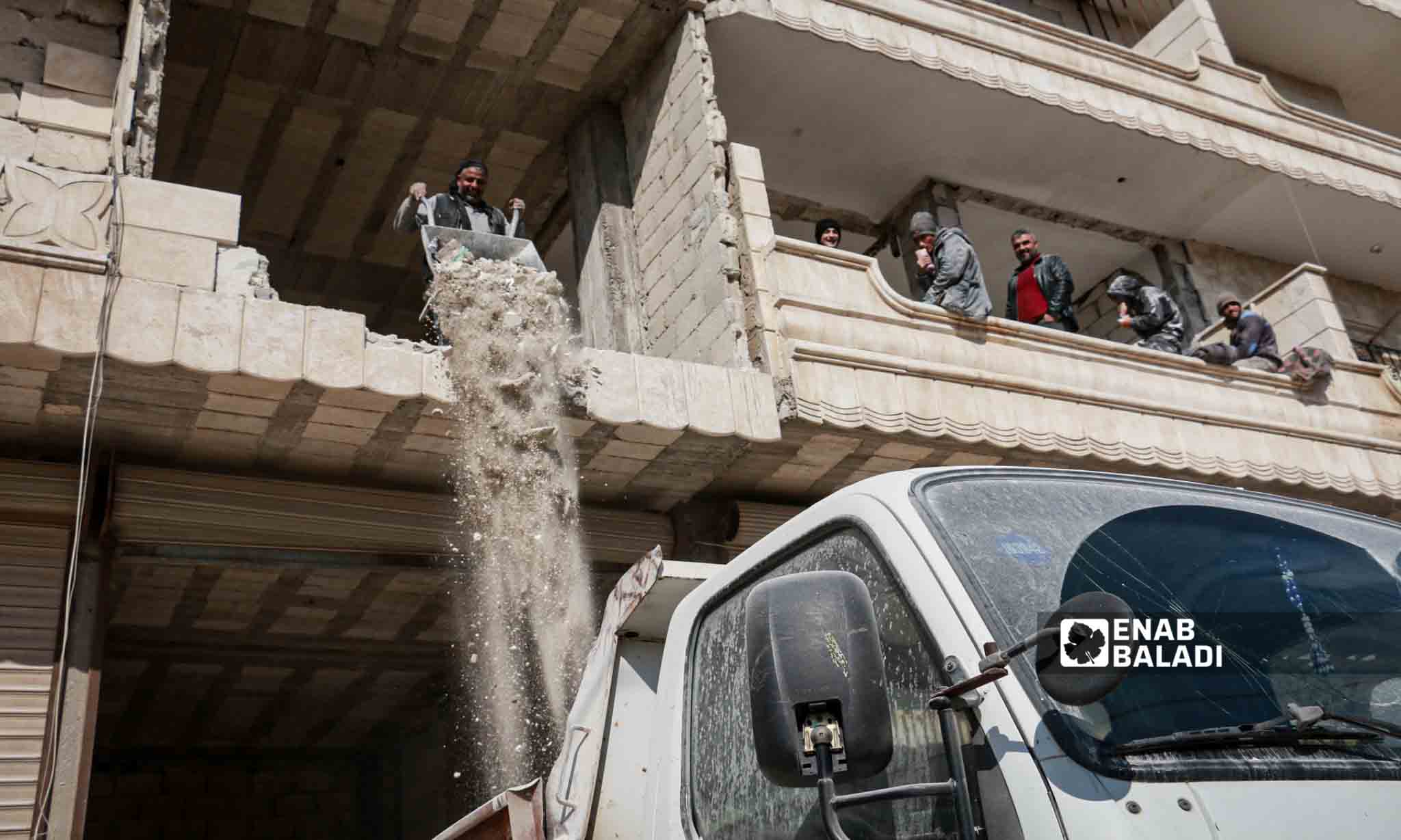 A man removing debris from a house in Jindires, northwest Syria - February 6, 2024 (Enab Baladi/Dayan Junpaz)