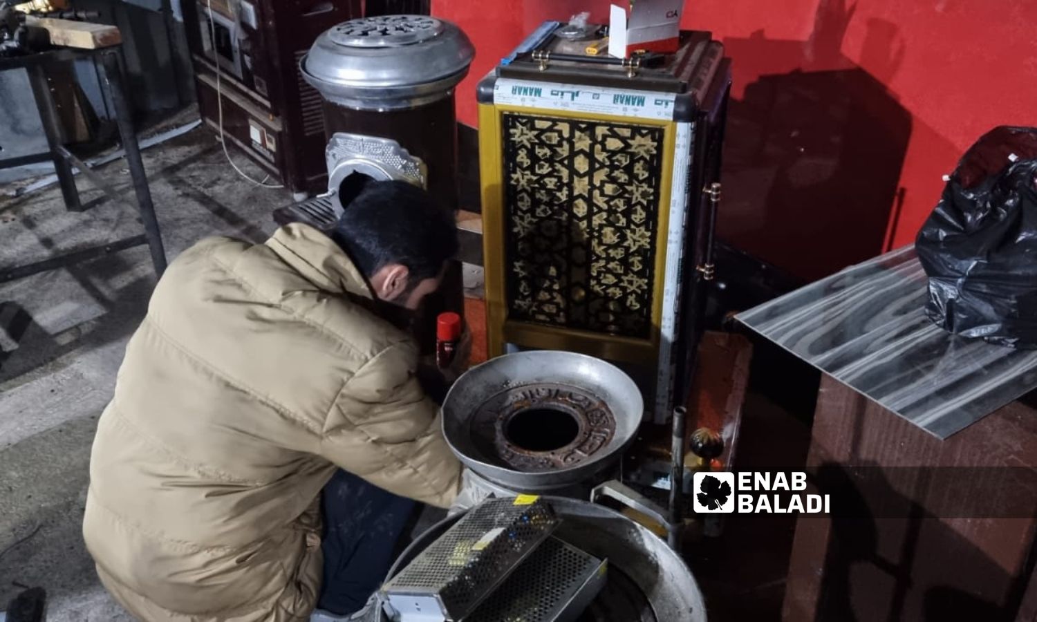A man conducts maintenance on a heating appliance in northwest Syria - January 18, 2024 (Enab Baladi/Anas al-Khouli)