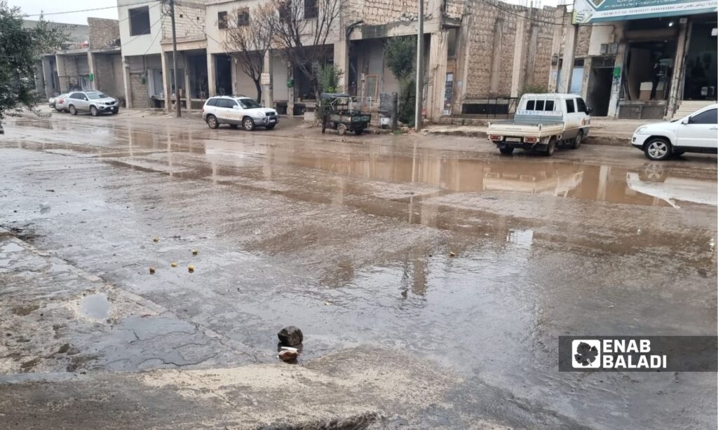 A road filled with potholes and water pools in Idlib - January 10, 2024 (Enab Baladi/Anas al-Khouli)