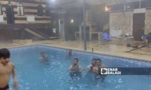 Young people gather to spend some time at a winter pool in Idlib - February 17, 2024 (Enab Baladi/Shams al-Din Matoun)
