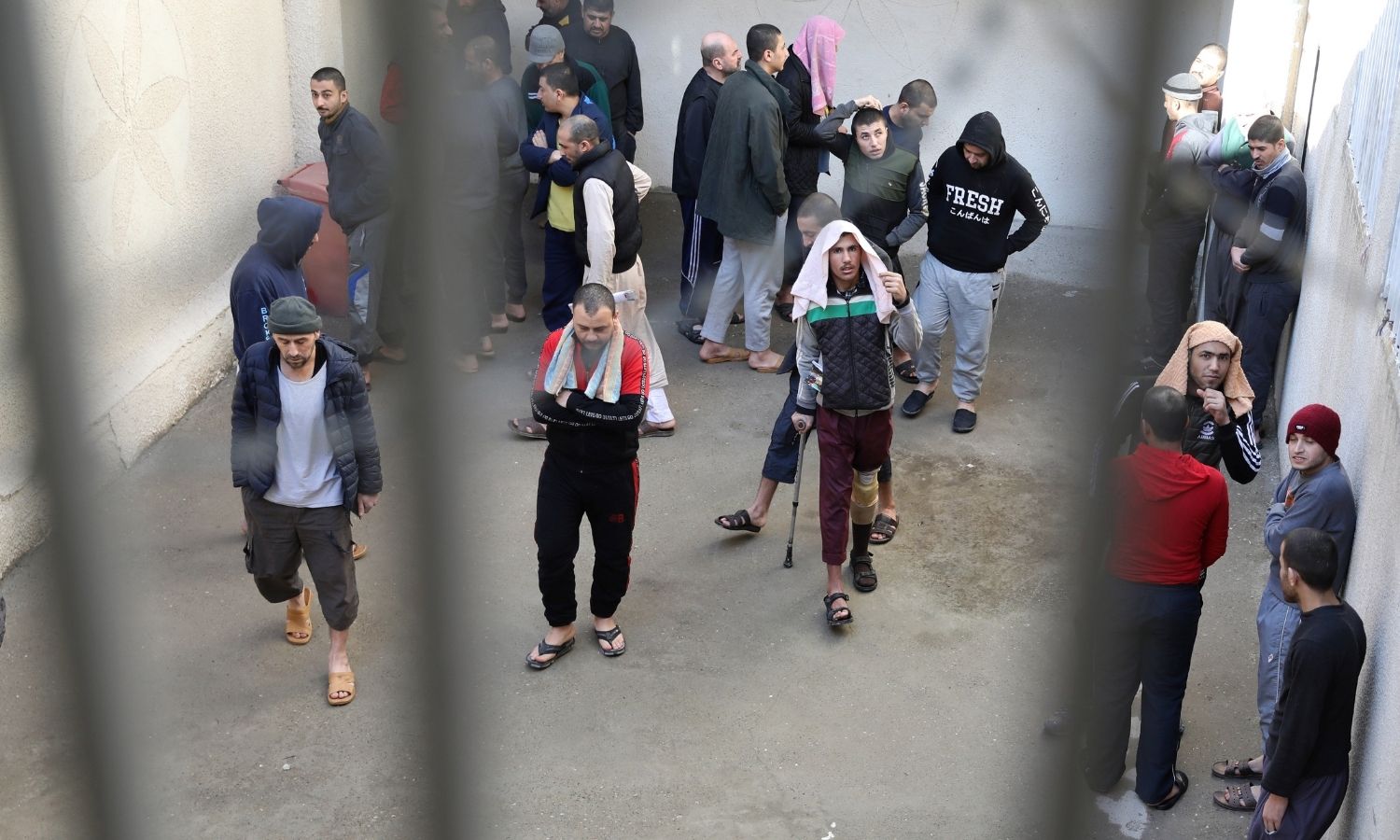 Prisoners from Iraq and Syria, believed to be members of the Islamic State, in a prison yard in al-Hasakah city - February 12, 2020 (Reuters)