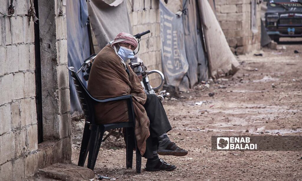 A man sits near his tent in the Fukara'a Allah camp in the countryside of Idlib, northern Syria - November 22, 2023 (Enab Baladi/Iyad Abdul Jawad)