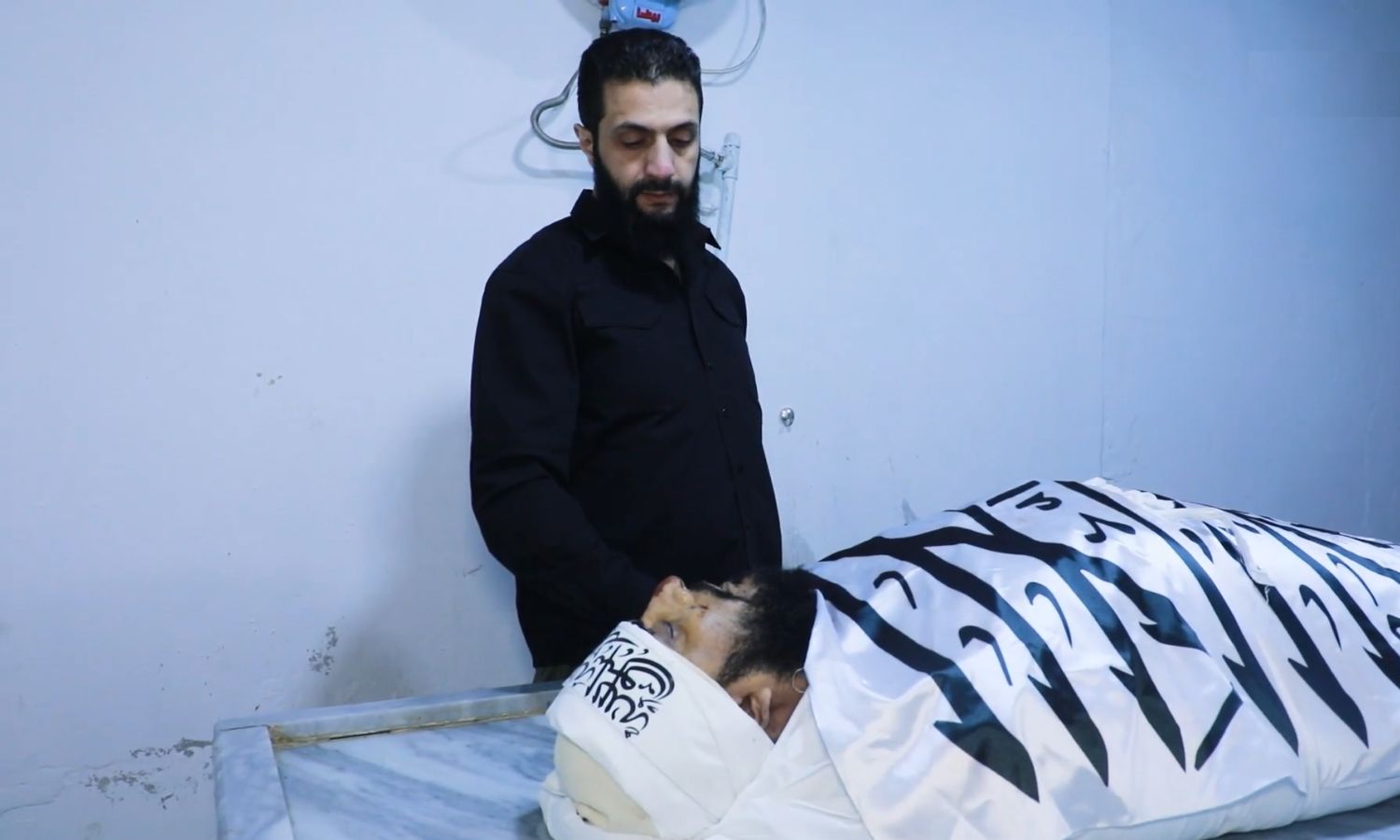 Abu Mohammad al-Jolani, the leader of Hayat Tahrir al-Sham, next to the body of Abu Maria al-Qahtani - April 5, 2024 (Amjad)