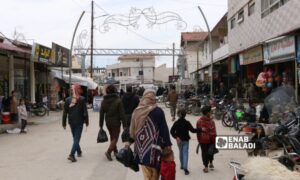 Some residents carrying black plastic bags in the streets of Ras al-Ain, northwest of al-Hasakah, March 25, 2024 (Enab Baladi)