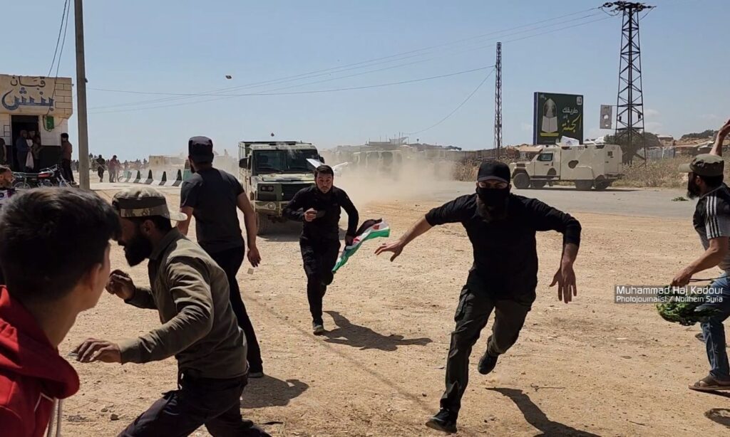 Elements from Hayat Tahrir al-Sham chase protesters in Binnish city, east of Idlib - May 17, 2024 (Mohammed Haj Kadour/Facebook)