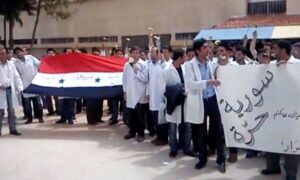 Medical students during a silent sit-in at their faculty, holding flowers and demanding the release of their detained colleagues - April 19, 2011 (YouTube/obaybol)
