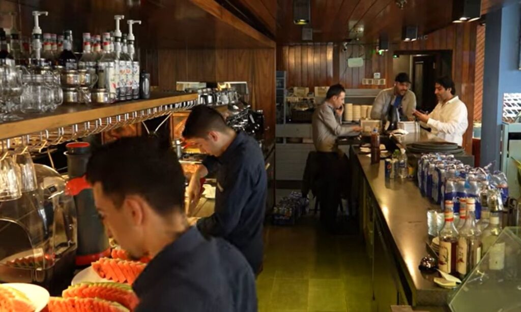 Workers inside a restaurant in Erbil city - 2024 (Screenshot/YouTube)