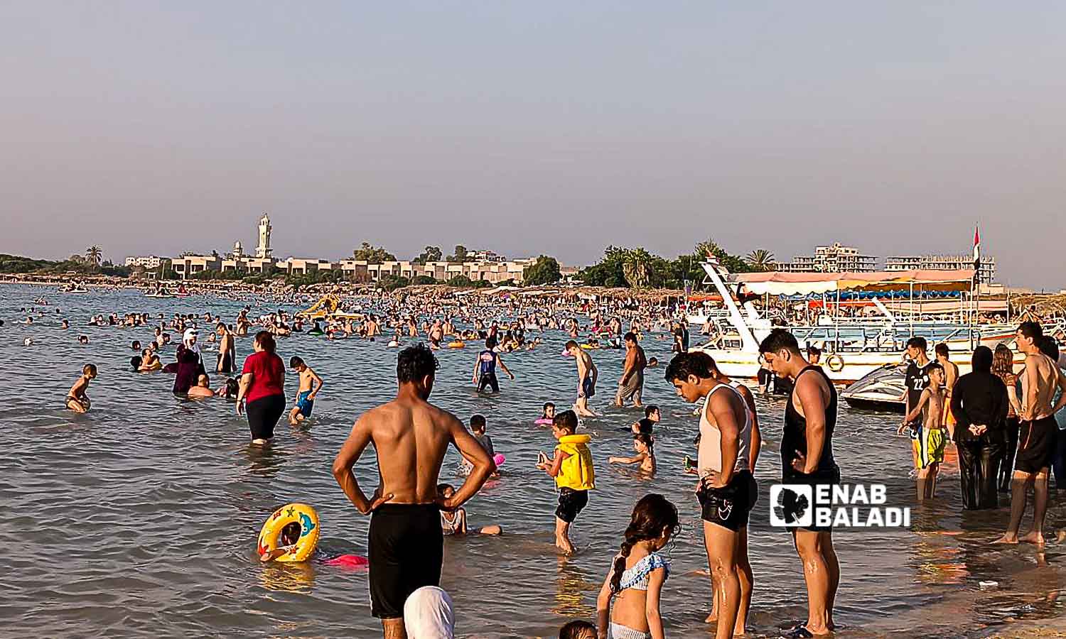 Young people on the Karnak Beach in the Blue Beach area in Latakia - July 23, 2024 (Enab Baladi/Linda Ali)
