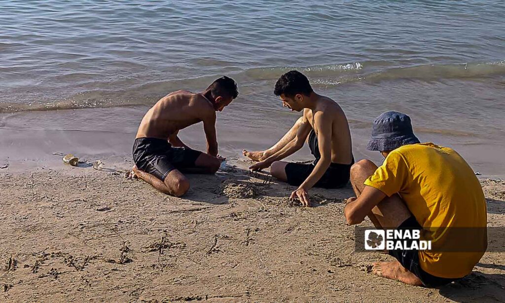 Young people on the Karnak Beach in the Blue Beach area in Latakia - July 23, 2024 (Enab Baladi/Linda Ali)