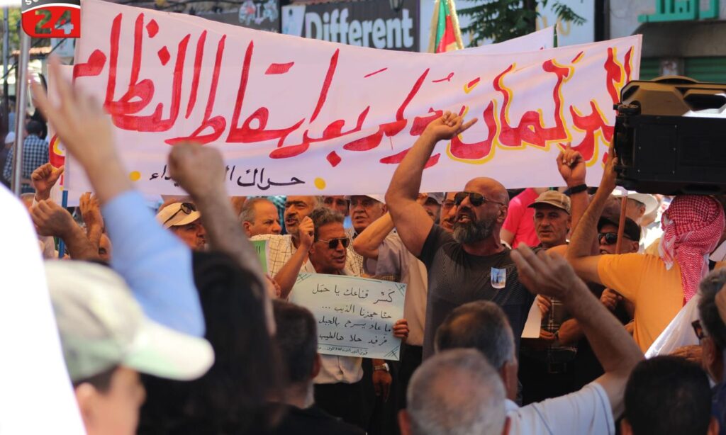 A protest banner displayed in the al-Karama Square in As-Suwayda, calling for a boycott of the People's Assembly elections - July 12, 2024 (Suwayda 24)