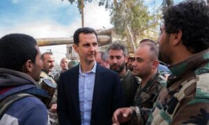 Bashar al-Assad with elements of the regime forces in Eastern Ghouta after taking control - March 18, 2018 (Syrian Presidency)